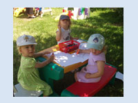 Drawing in the shade - we have a lovely garden and many activities take place outside in the finer weather.  We take great care to keep children protected from the sun.