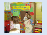 Roleplay  refreshments - as part of our topic on 'The Circus' the youngest children painted a huge box and the older children turned it into a refreshment stand offering refreshments when the clown was performing.